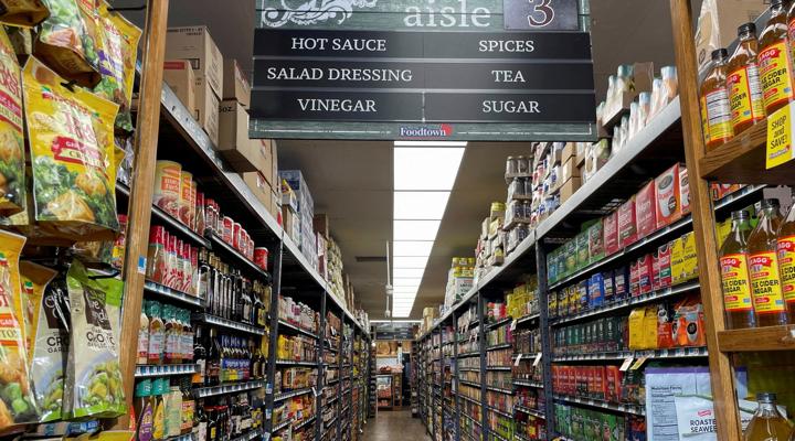 Supermarket aisle with sauces and spices.