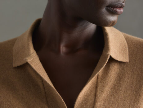 A male model wearing a camel brown Quince cashmere shirt.