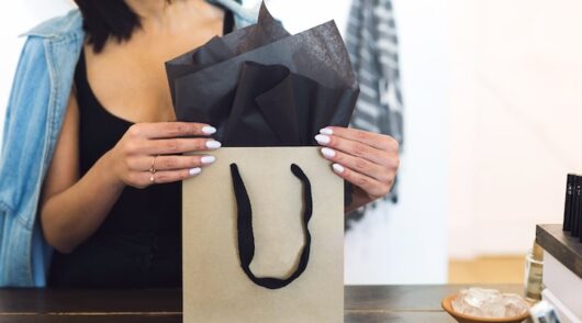 Women packing a purchase at store counter