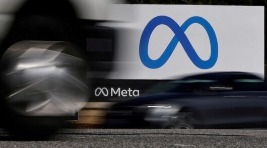 Cars drive past a sign of Meta, the new name for the company formerly known as Facebook, at its headquarters in Menlo Park, California.