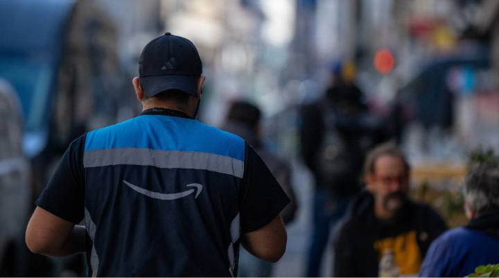 Amazon worker walking in city.