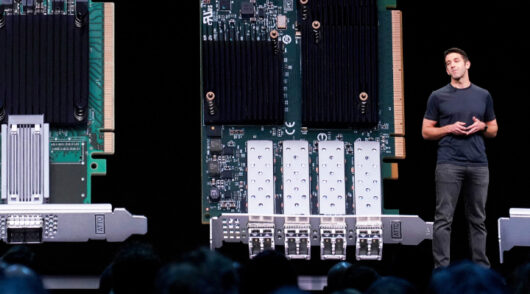 Apple exec presents hardware on stage.