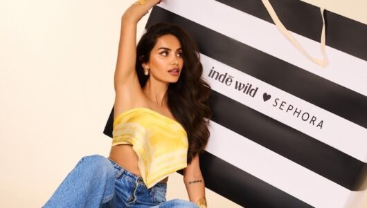 Indē Wild founder Diipa Büller-Khosla holding an oversized Sephora bag.