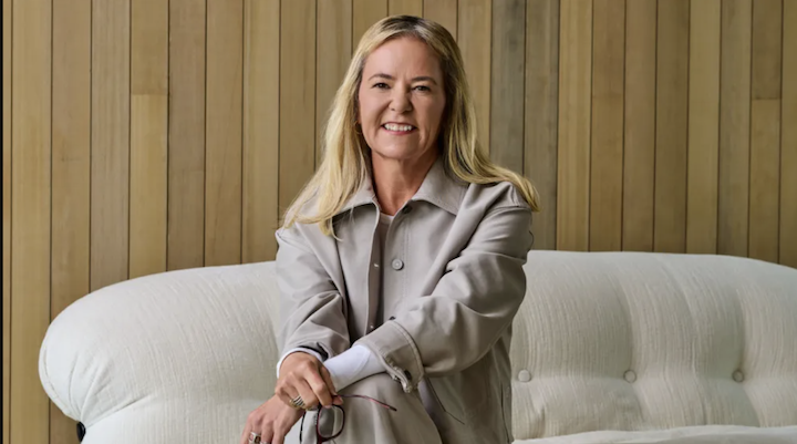 Lululemon’s newly appointed CEO Heidi O'Neill sitting on a white couch.
