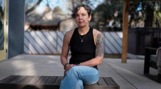 Woman seated outdoors portrait.