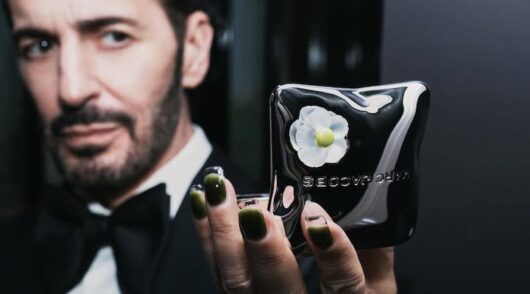 Designer Marc Jacobs holding a bronzer from Marc Jacobs Beauty.