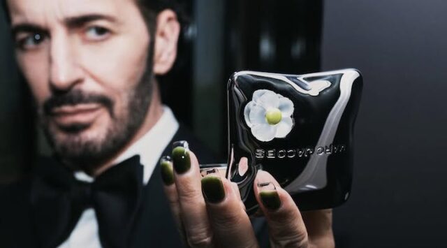 Designer Marc Jacobs holding a bronzer from Marc Jacobs Beauty.