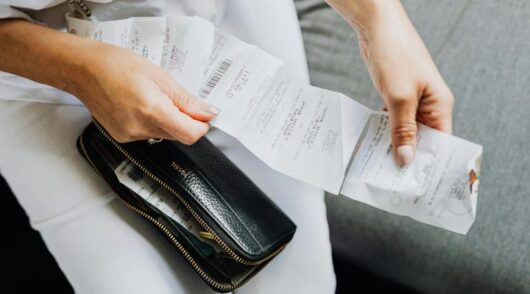 Shopper holding receipts.