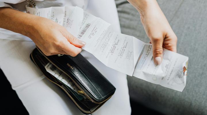 Shopper holding receipts.