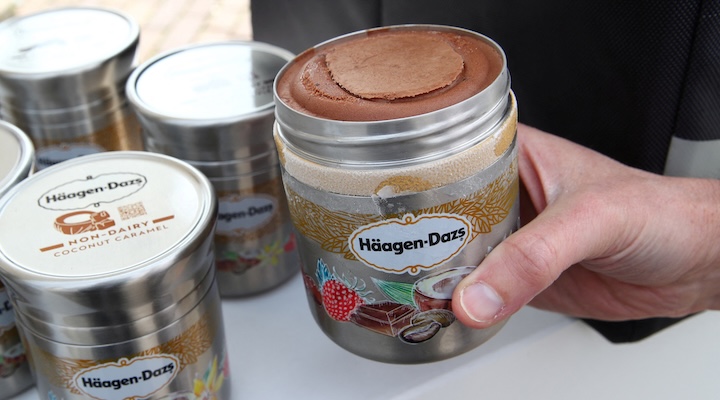 A staff displays a reusable container of Haagen Dazs ice cream before the opening of the 152nd Annual General Meeting of Nestle in Lausanne, Switzerland April 11