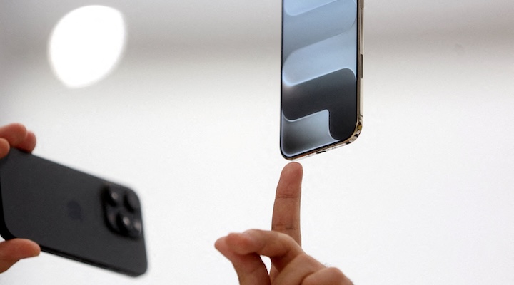 A person points to an iPhone during Apple's event at the Steve Jobs Theater on its campus in Cupertino