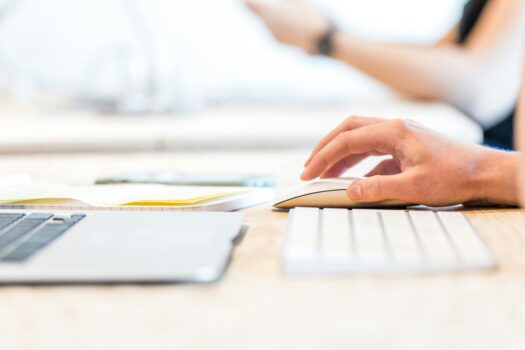 Hand using a computer mouse.