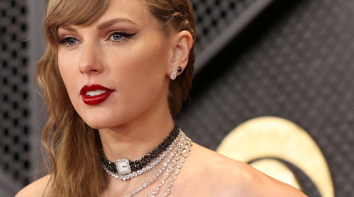 Taylor Swift poses on the red carpet as she attends the 66th Annual Grammy Awards in Los Angeles