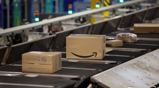 Boxes of customer orders move along a conveyor belt at Amazon's LCY3 fulfilment centre in Dartford