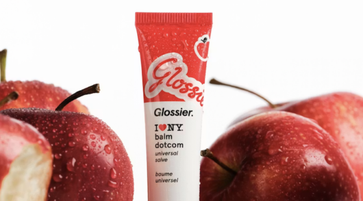 An apple-themed Glossier Balm Dotcom product.