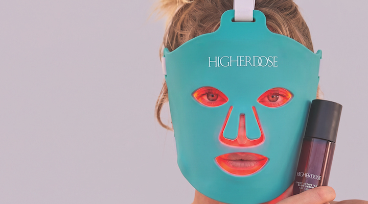 A blond model wearing a HigherDose infrared mask.