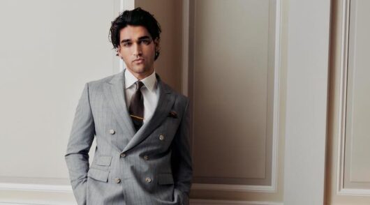 Australian actor Josh Heuston in a grey Hugo Boss suit.