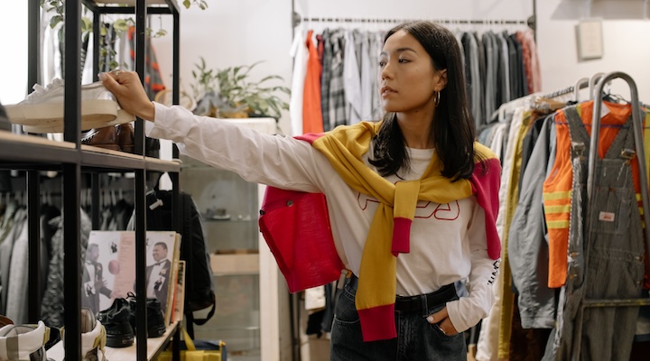 Woman browsing clothing in US retail store