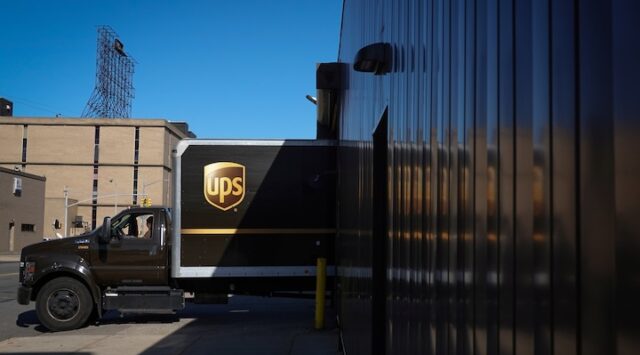 A United Parcel Service (UPS) vehicle reverses into a facility