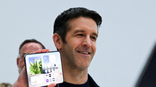 John Ternus holds the iPhone Duo.