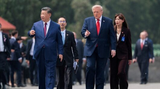 Trump and Xi walk during talks.