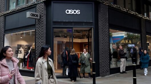 People walk past the Asos pop-up store in London