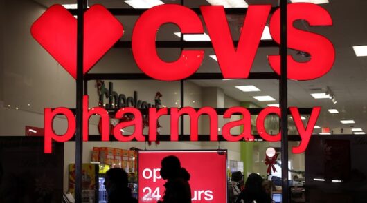 People walk by a CVS pharmacy store in Manhattan, New York City