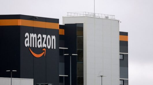 The logo of Amazon is seen at the company's logistics center